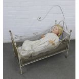 Late 19th / early 20th century white painted metal crib with a German SP doll, 80 x 86 x 39cm (2)