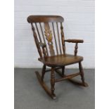 Child's elm Windsor rocking chair with a pierced splat and solid seat, 44 x 72 x 30cm