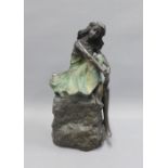 Bronze patinated resin figure of a seated female, 29cm high