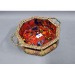 Octagonal glass bowl contained within a basket with handles tot he side, 24cm wide