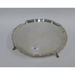 Silver salver of circular form with a piecrust edge and four scroll feet, Glasgow 1934, 30cm