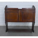 Mahogany wall cabinet with a pair of cupboard doors above a single shelf, with Gothic pierced motifs