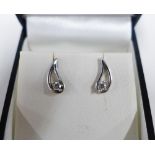 A pair of 9ct white gold and diamond earrings of tear drop shape