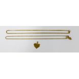 An unmarked gold heart shaped pendant and two yellow metal chains (3)
