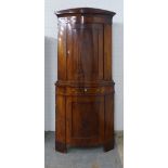 Early 19th century flame mahogany corner cabinet, floor standing in two parts, with shelved interior