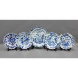 Collection of blue and white tin glazed plates, typically painted with flowers and foliage, some