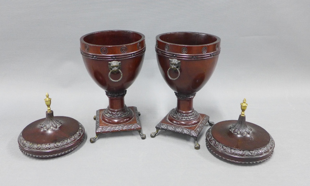 A pair of stained wooden urn vases with domed covers and brass finials, on brass claw and ball feet, - Image 2 of 2
