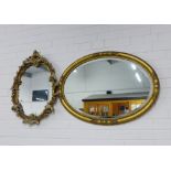 Oval gilt mirror with a bevelled plate, 83cm, and a rococo style wall mirror, (2)