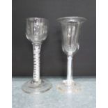 Two cordial glasses, one with an opaque spiral twist stem the other with a trumpet bowl and red,