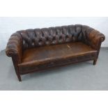 Brown leather Chesterfield sofa on wooden legs, (a/f) 177 x 77 x 48cm