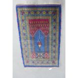 Eastern prayer mat, blue field with a hanging lantern pattern within a flowerhead border, 88 x 140cm