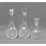 Three cut glass decanters and stoppers with pewter decanter labels, (a lot)