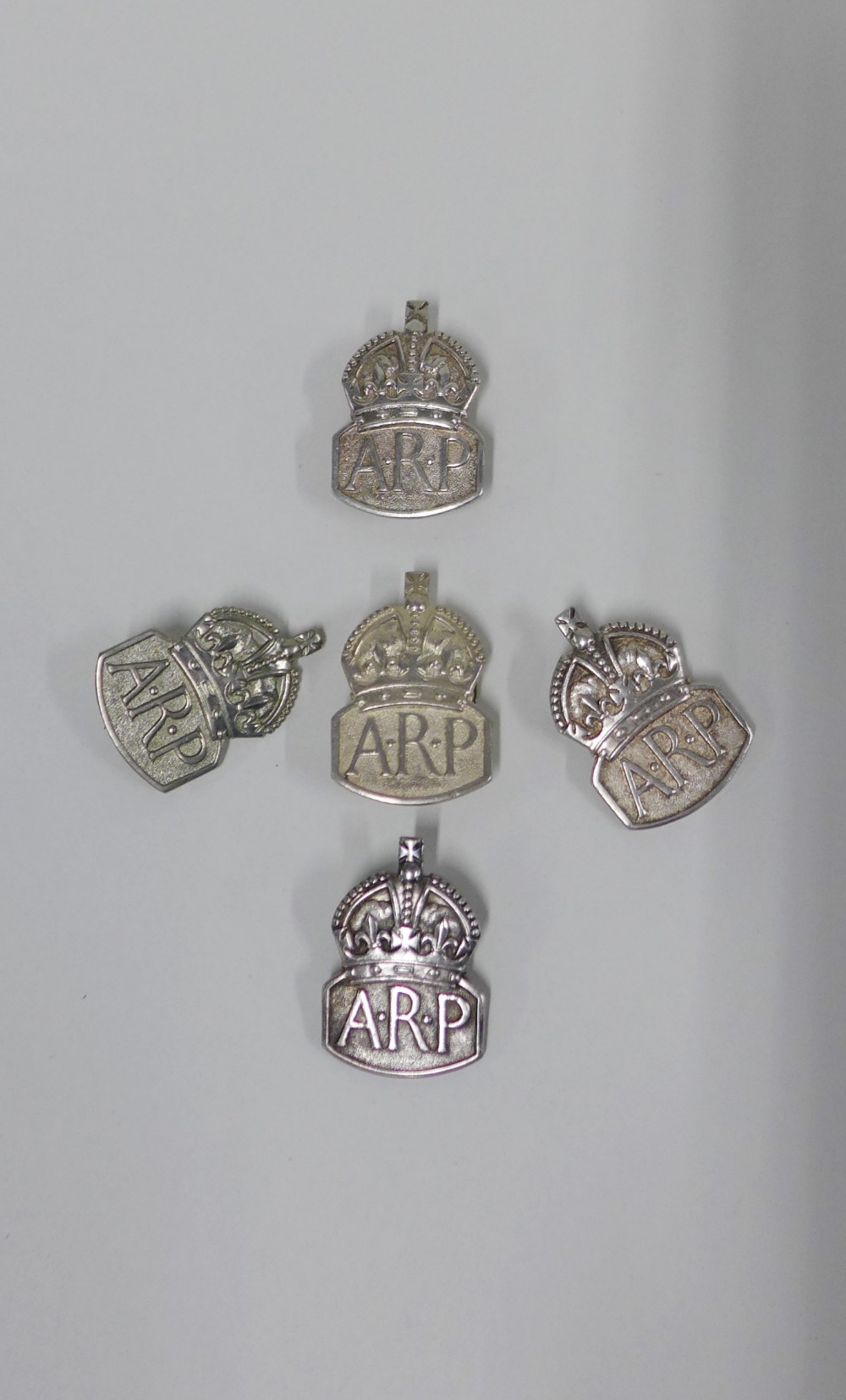 A group of five hallmarked silver ARP badges, (5)