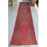 Turkish runner, red field with five central medallions, multiple borders,(a/f) 96 x 380 approx