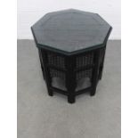 Moorish style ebonised table,octagonal top with brass inlay, pierced sides and glass top, 56 x 57cm