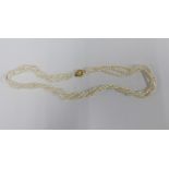 A three strand freshwater pearl necklace.