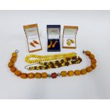 Two pairs of 9ct gold and amber drop earrings, a pair of silver an amber earrings and various