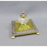 Brass and mixed metal desk inkstand of square outline, with a glass inkwell, on bun feet, 16cm