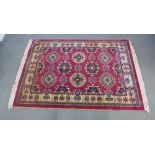 Persian style wool rug with red field and six medallions, 172 x 122cm
