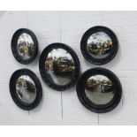 A group of five convex wall mirrors with black painted circular frames, largest 58cm, smallest