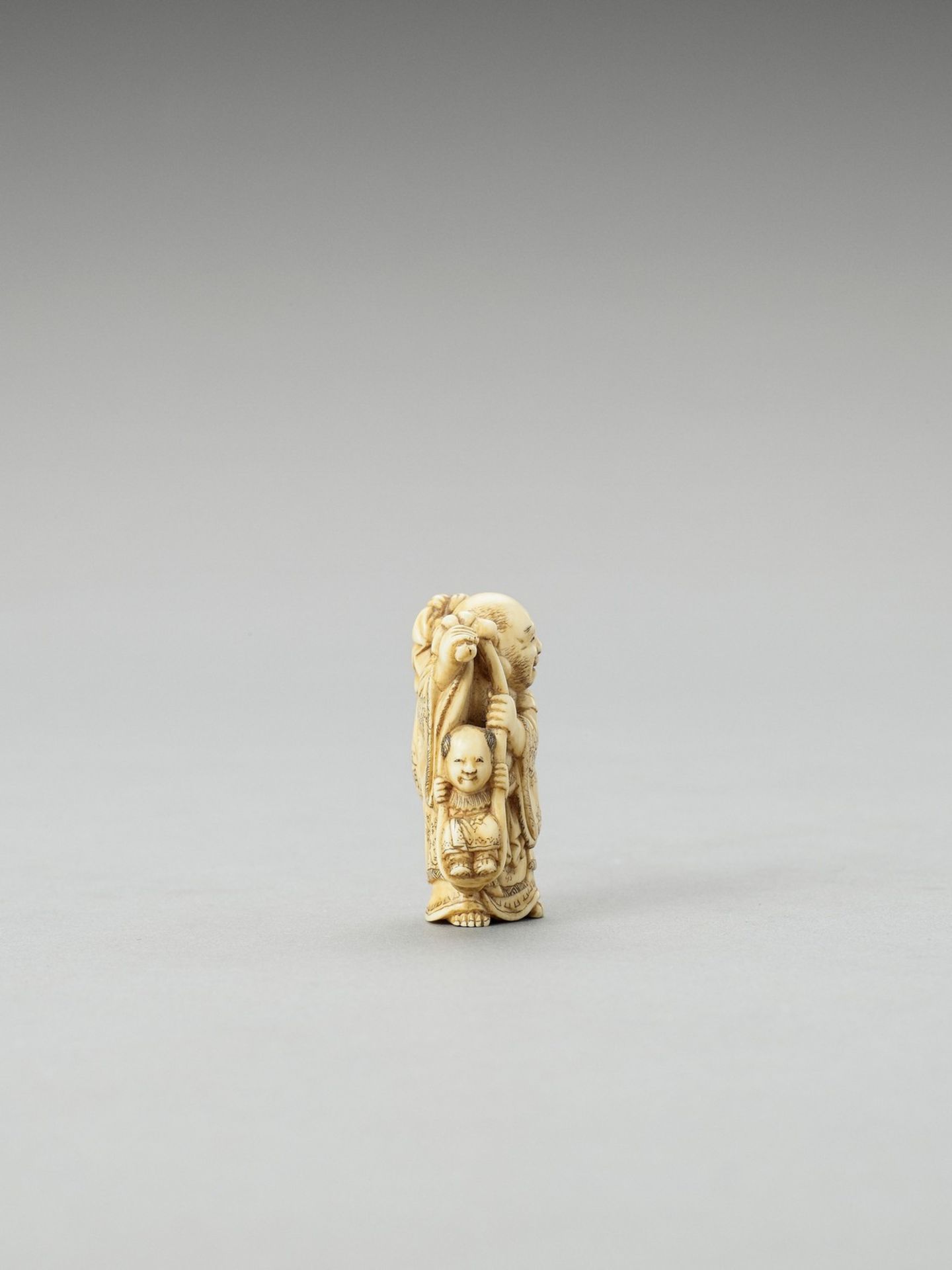 TOMOAKI: AN IVORY NETSUKE OF HOTEI CARRYING A KARAKO - Bild 4 aus 4