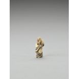 AN IVORY NETSUKE OF DARUMA LAUGHING