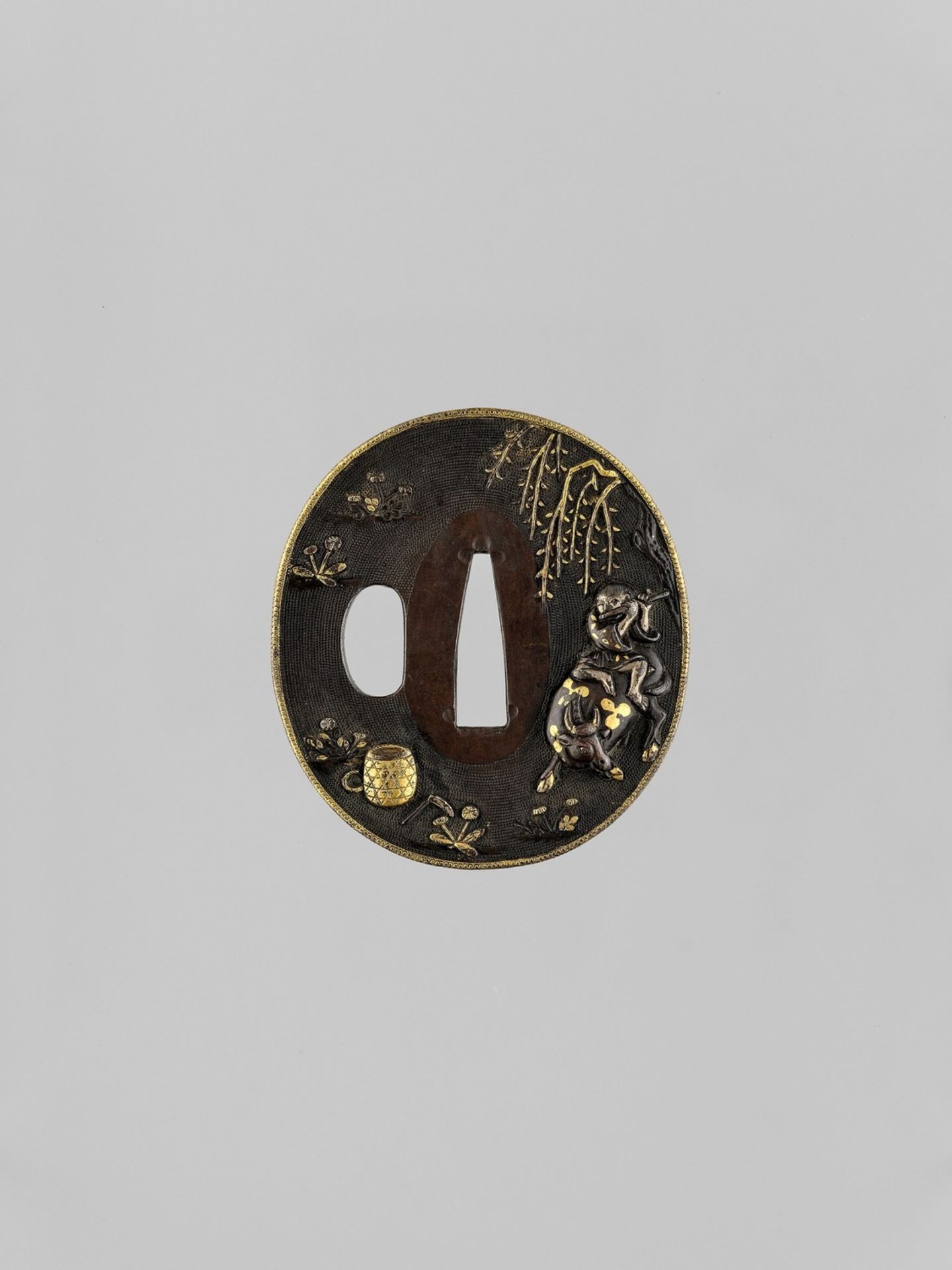 A GOLD AND SILVER-INLAID SHAKUDO TSUBA WITH OX AND BOKUDO