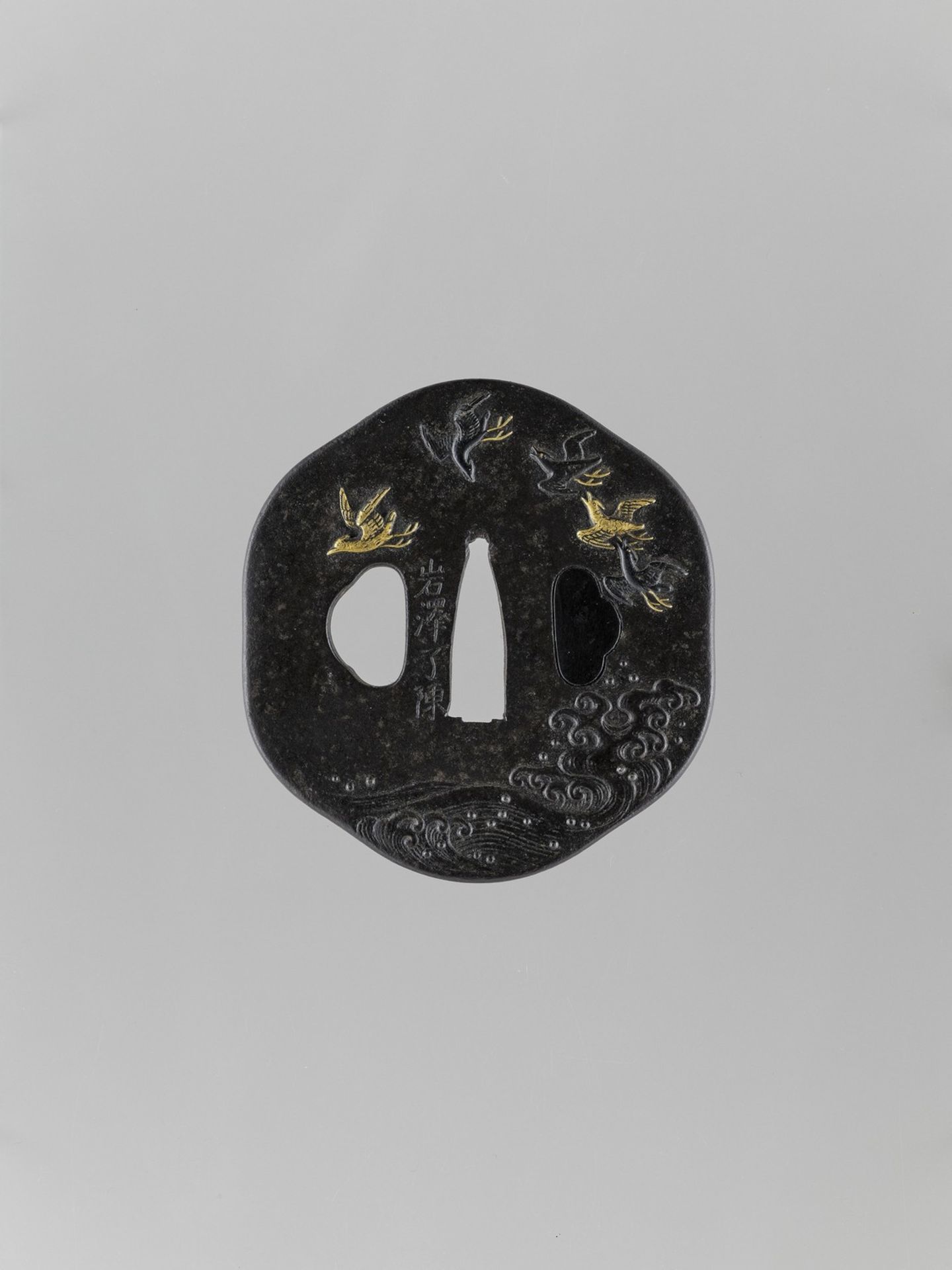 AN INLAID IRON TSUBA WITH FLYING GEESE