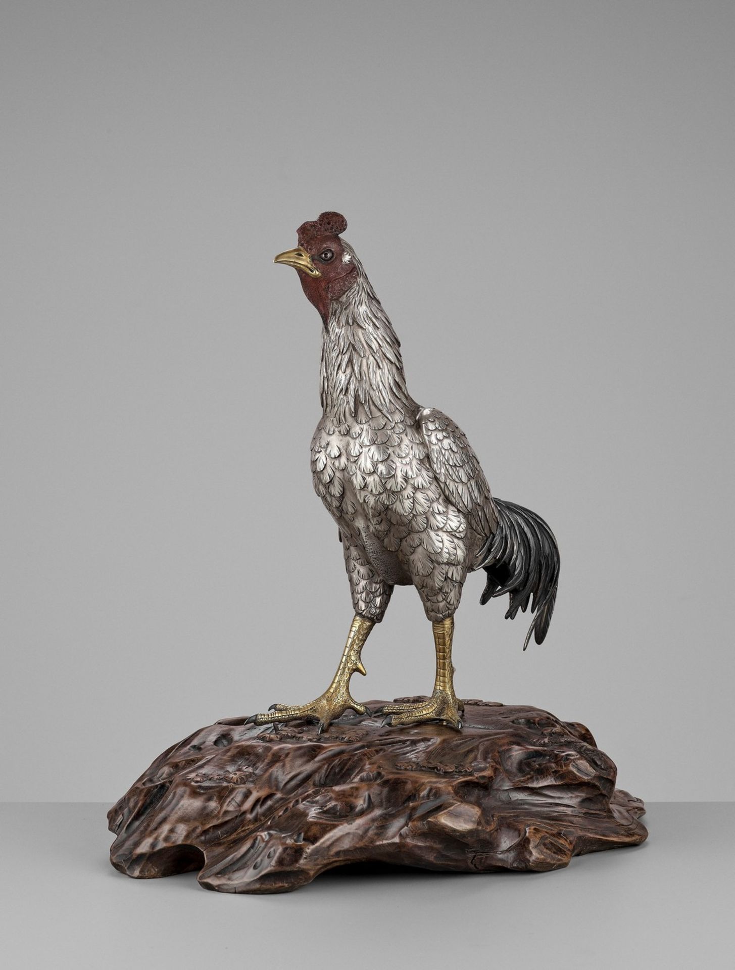 SEIYA: AN UNUSUAL AND RARE PARCEL-GILT SILVERED BRONZE OKIMONO OF A COCKEREL