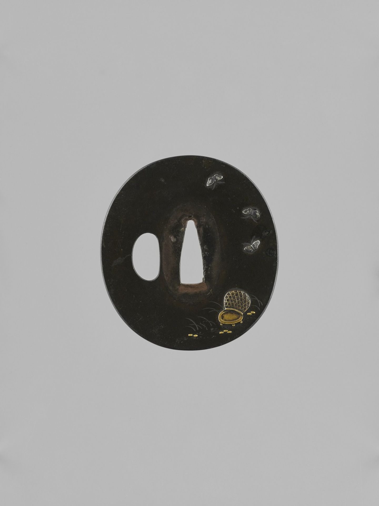 A SHIBUICHI TSUBA WITH BUTTERFLIES AND BASKET