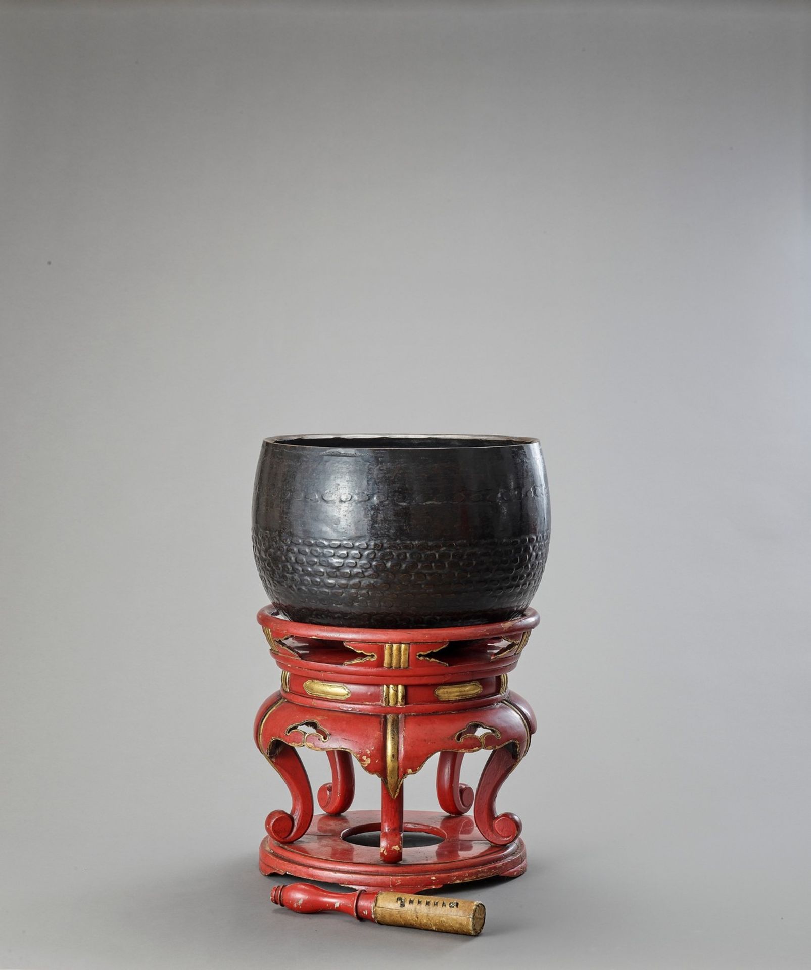 A BUDDHIST BRONZE GONG ON A LACQUERED WOOD STAND