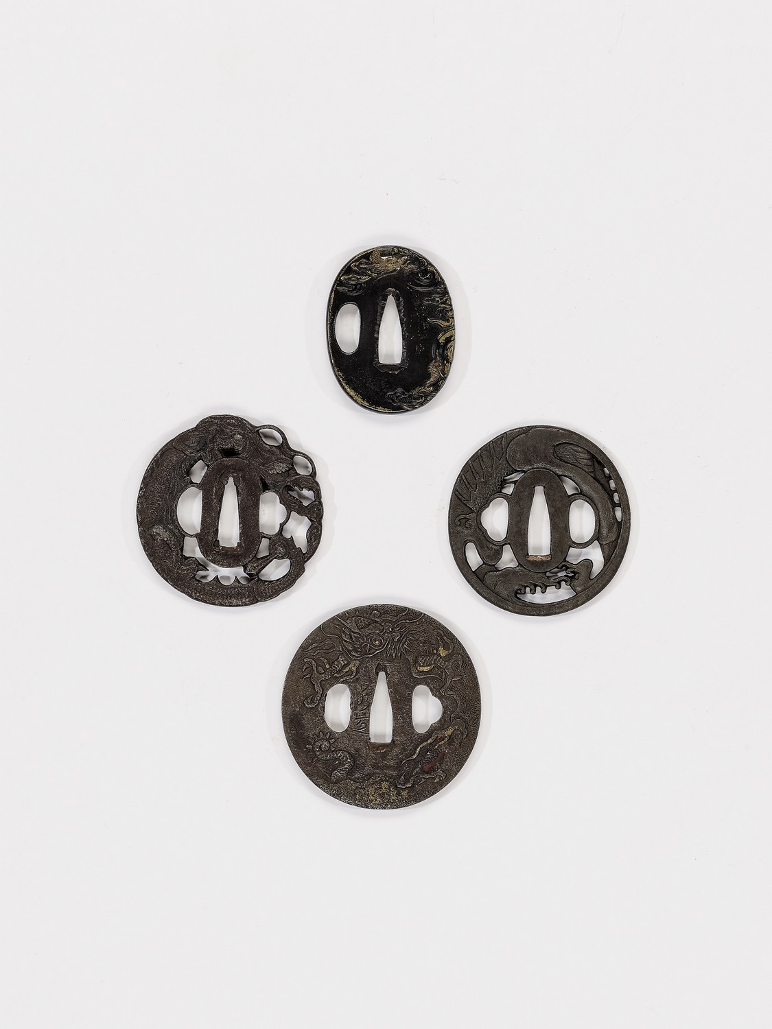 FOUR TSUBA DEPICTING DRAGONS