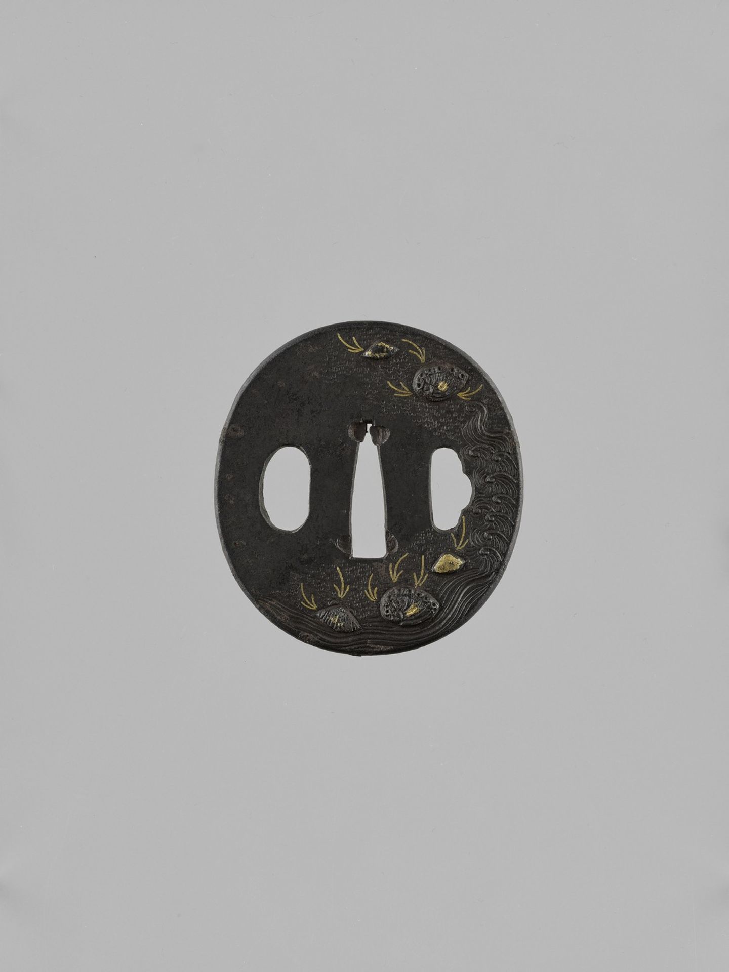 AN IRON TSUBA WITH SEASHELLS