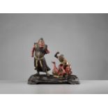 A RARE MUROMACHI PERIOD POLYCHROME WOOD GROUP WITH SHOKI AND ONI