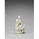 A WHITE GLAZED DEHUA PORCELAIN FIGURE OF GUANYIN AND CHILD, QING