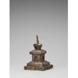 A TIBETAN COPPER REPOUSSÉ STUPA WITH TURQUOISES, 19TH CENTURY