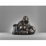 A LARGE AND HEAVILY CAST BRONZE FIGURE OF BUDAI, QING DYNASTY