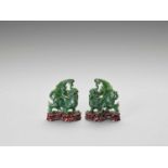 A PAIR OF SPINACH-GREEN JADE FIGURES OF QILIN, LATE QING TO REPUBLIC