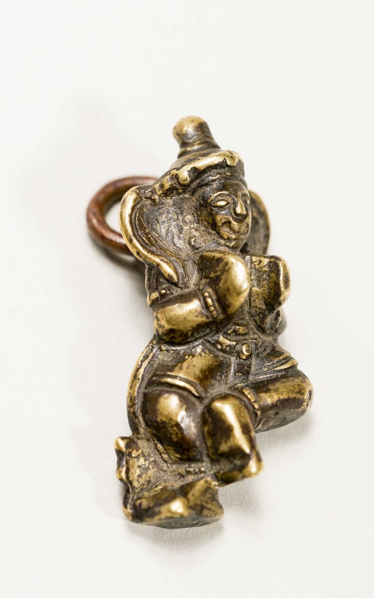 A TIBETAN MINIATURE BRONZE OF A DANCING BODHISATTVA