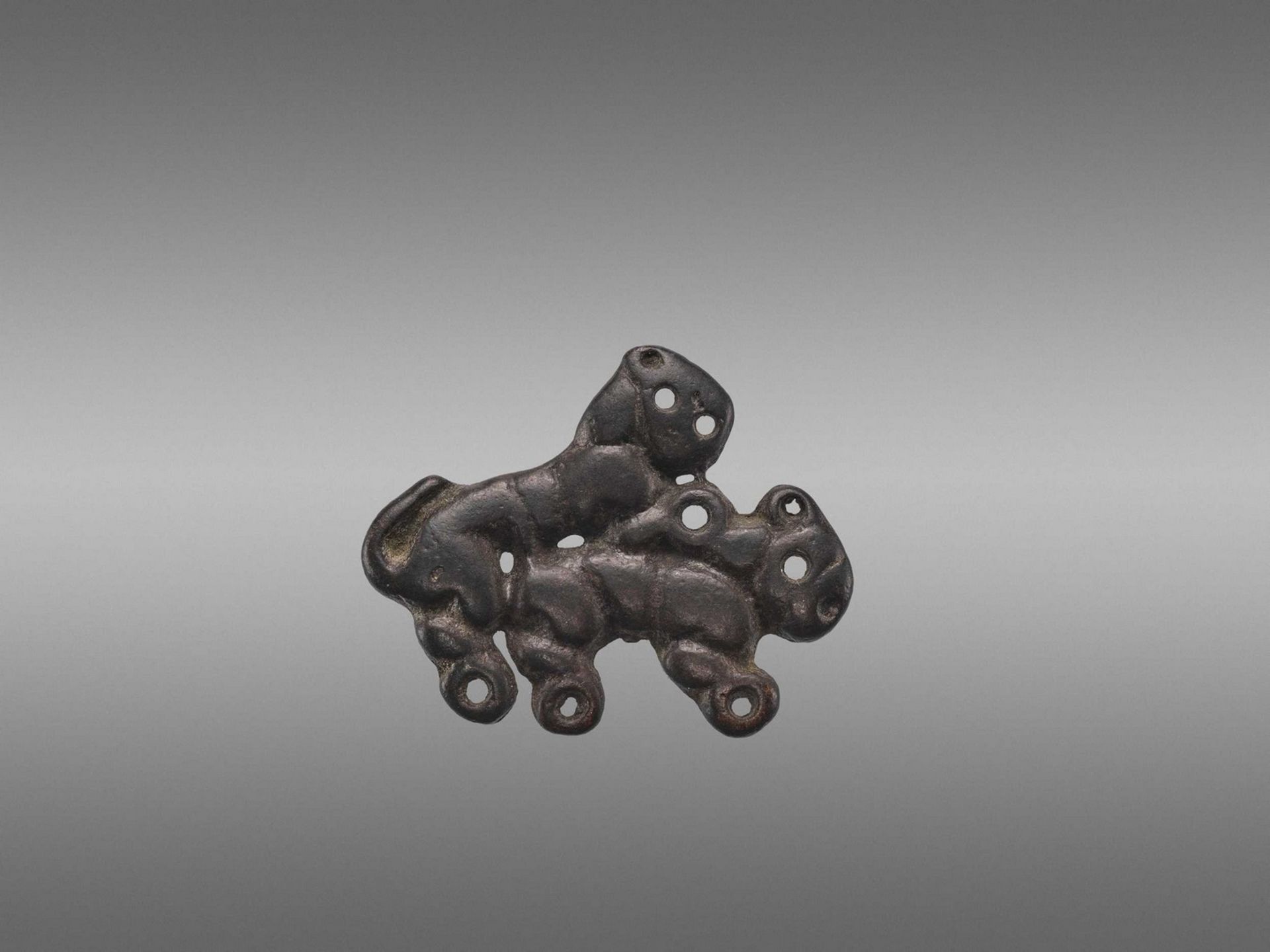 AN ORDOS BRONZE ‘COPULATING TIGERS’ PLAQUE, WARRING STATES