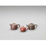 THREE YIXING TEAPOTS AND COVERS, LATE QING TO REPUBLIC