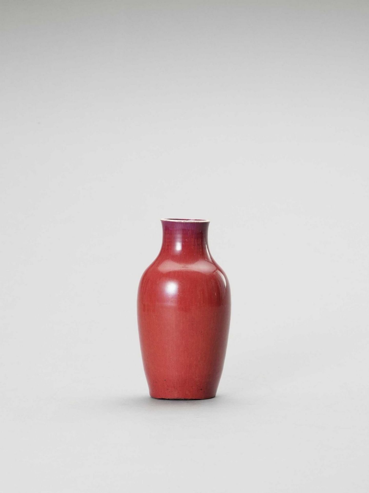 AN ‘OXBLOOD’ GLAZED BALUSTER VASE, QING