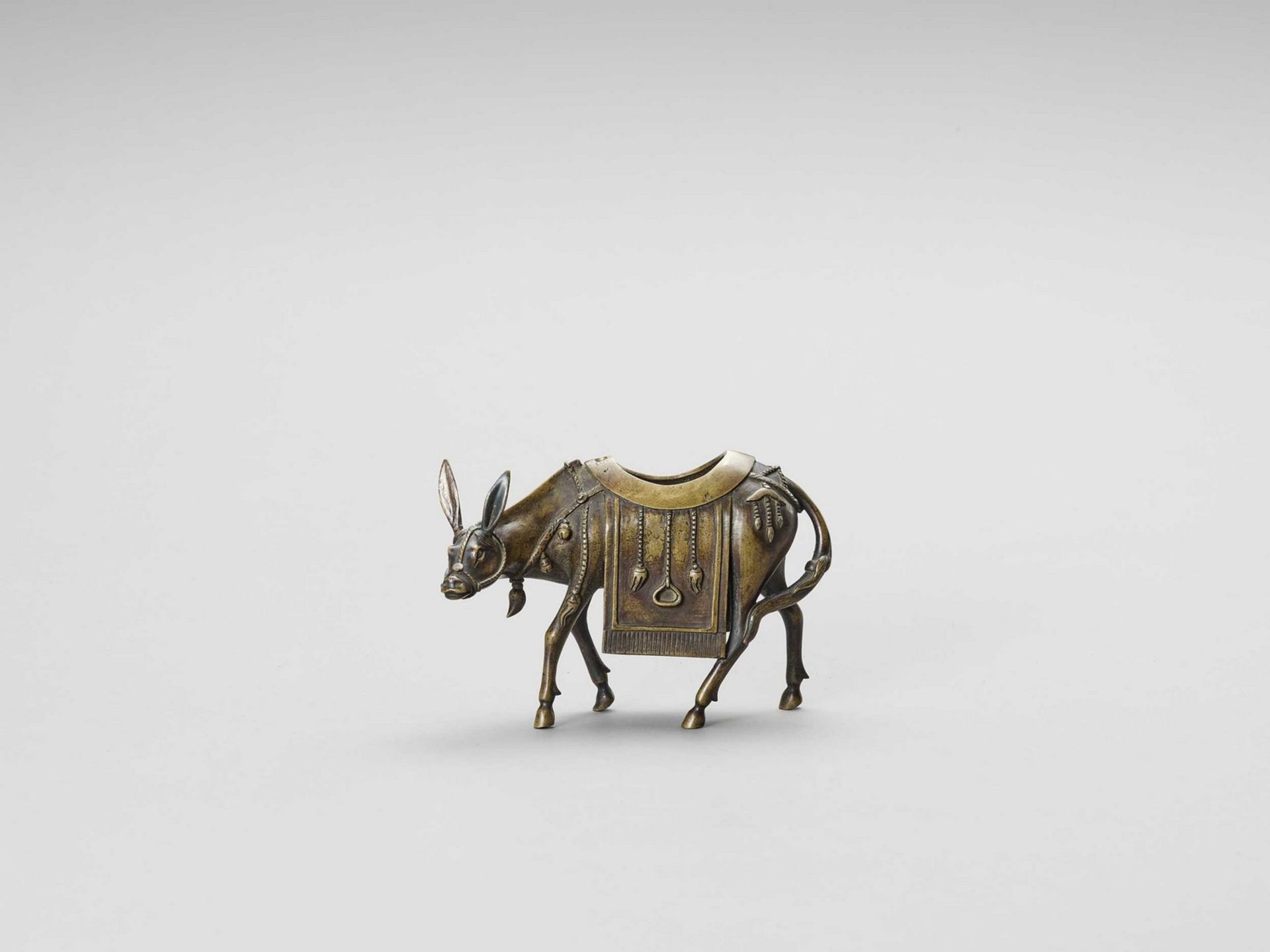 A BRONZE CENSER OF A CAPARISONED MULE