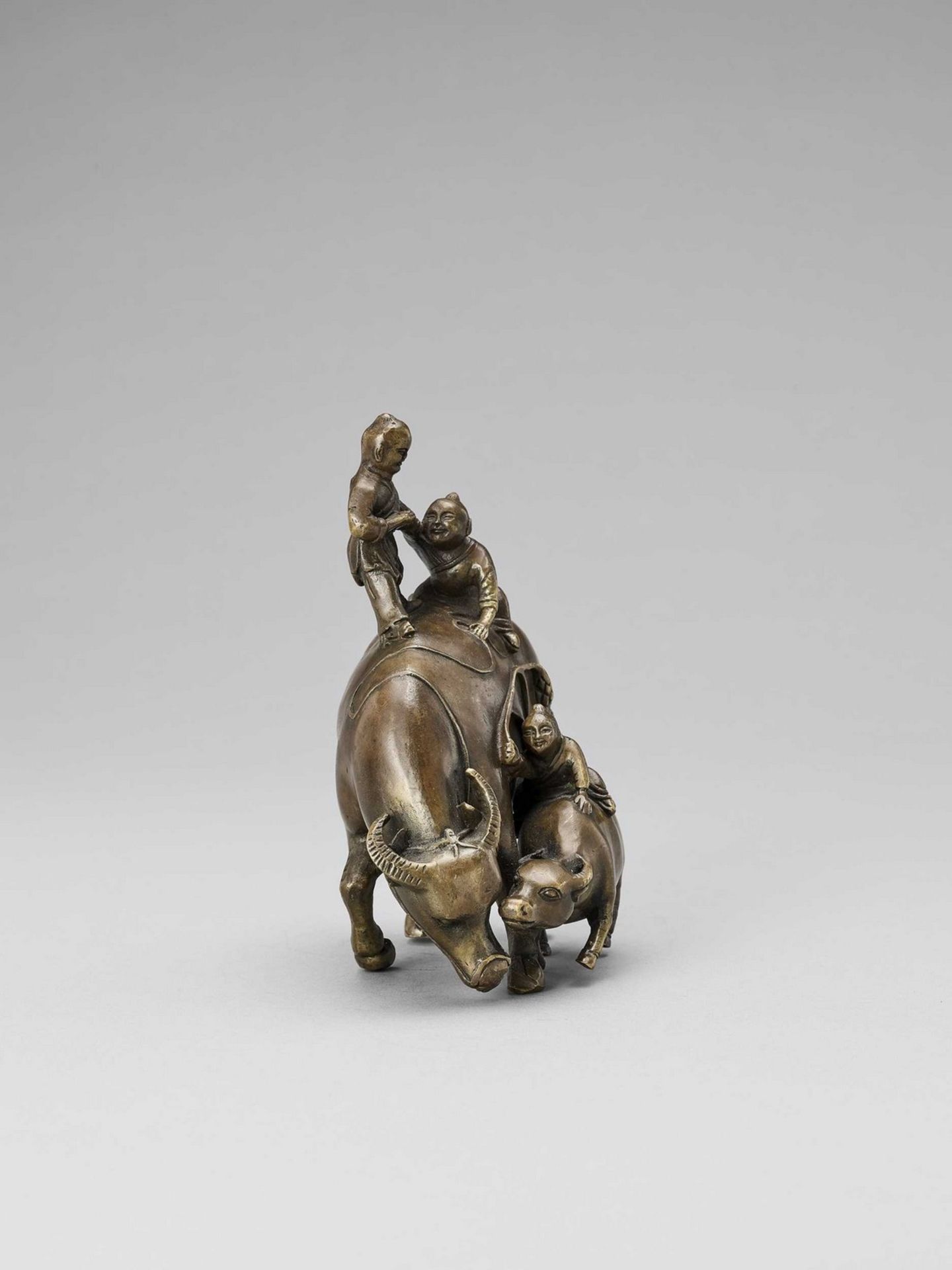 A BRONZE FIGURE OF BOYS ON BUFFALOS - Image 4 of 8