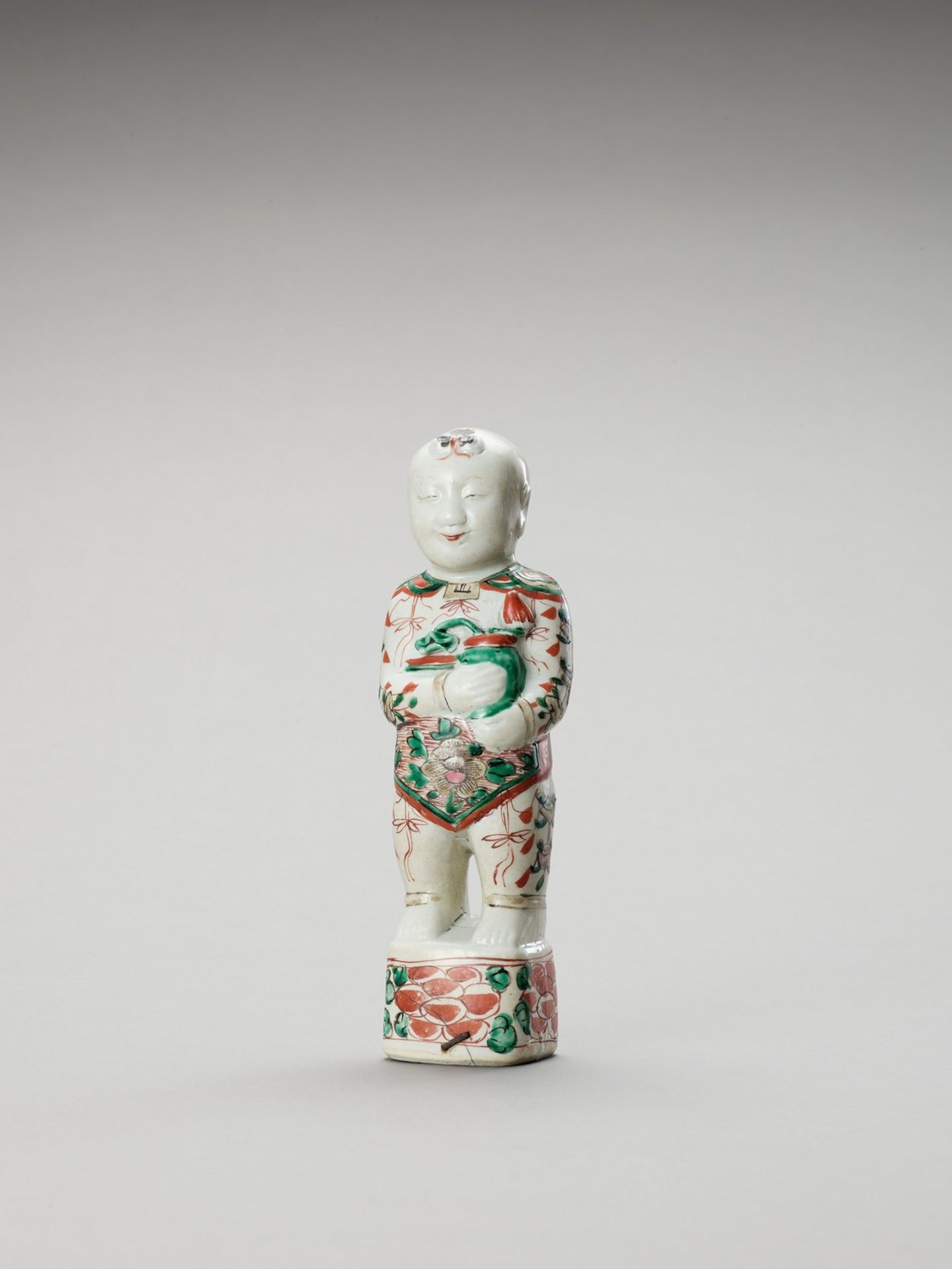 A FAMILLE VERTE PORCELAIN FIGURE OF A BOY