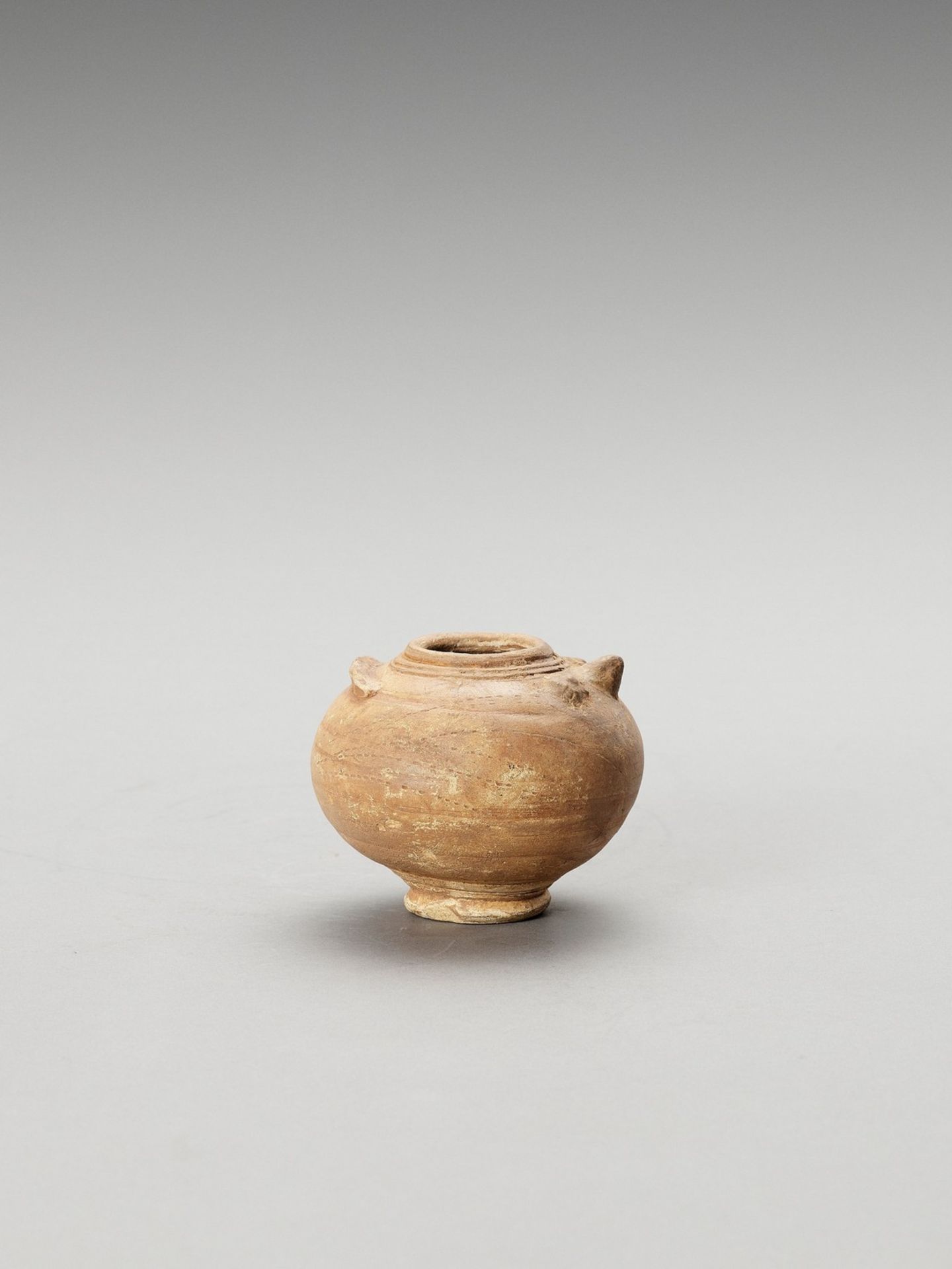 A SMALL CERAMIC VASE IN THE FORM OF AN OWL