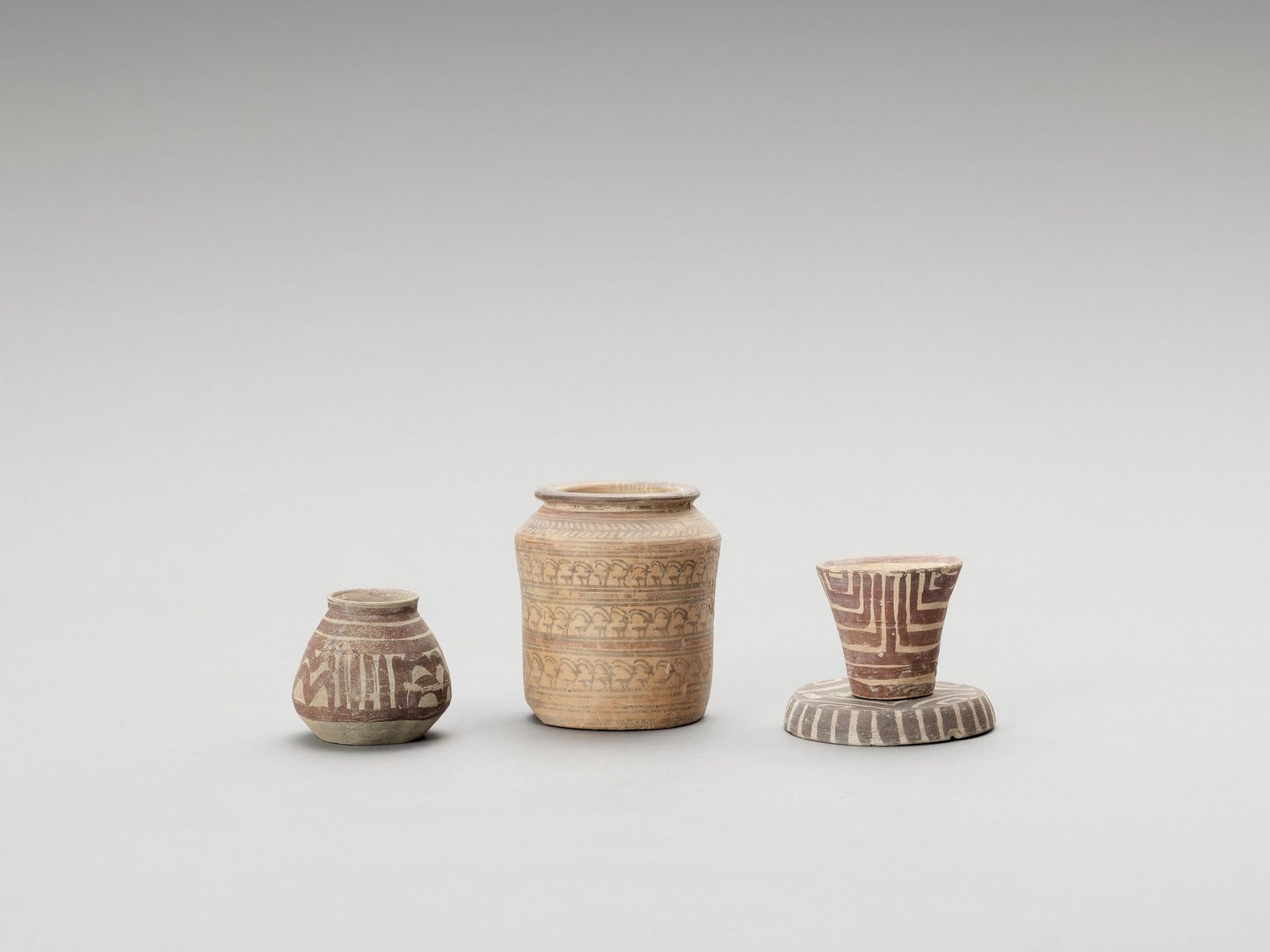 THREE MEHRGARH BUFF WARE VESSELS AND ONE JAR WITH NINDOWARI IBEXES