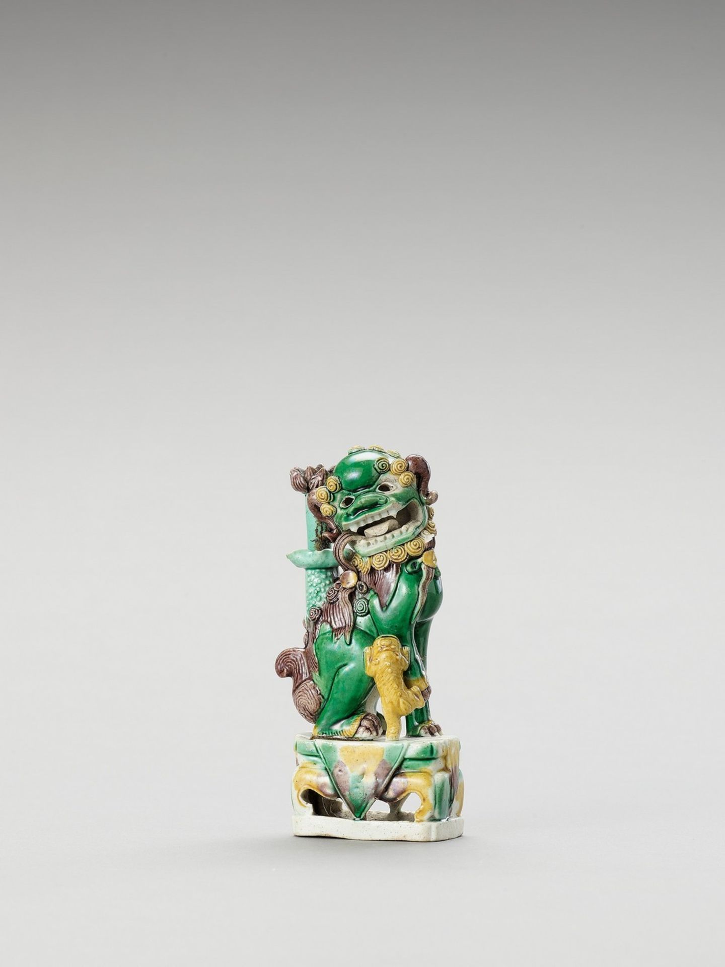 A FAMILLE VERTE ‘BUDDHIST LION’ PORCELAIN STICK HOLDER