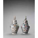 A LARGE PAIR OF IMARI PORCELAIN VASES AND COVERS