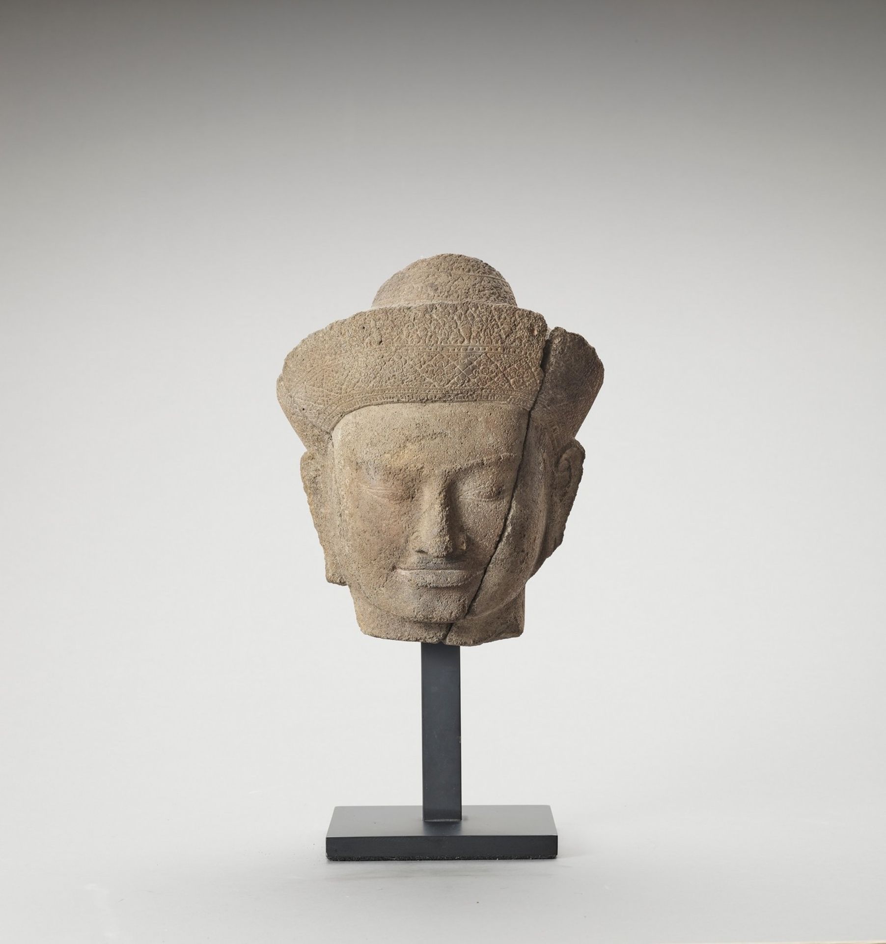 A KHMER SANDSTONE HEAD OF VISHNU, ANGKOR PERIOD